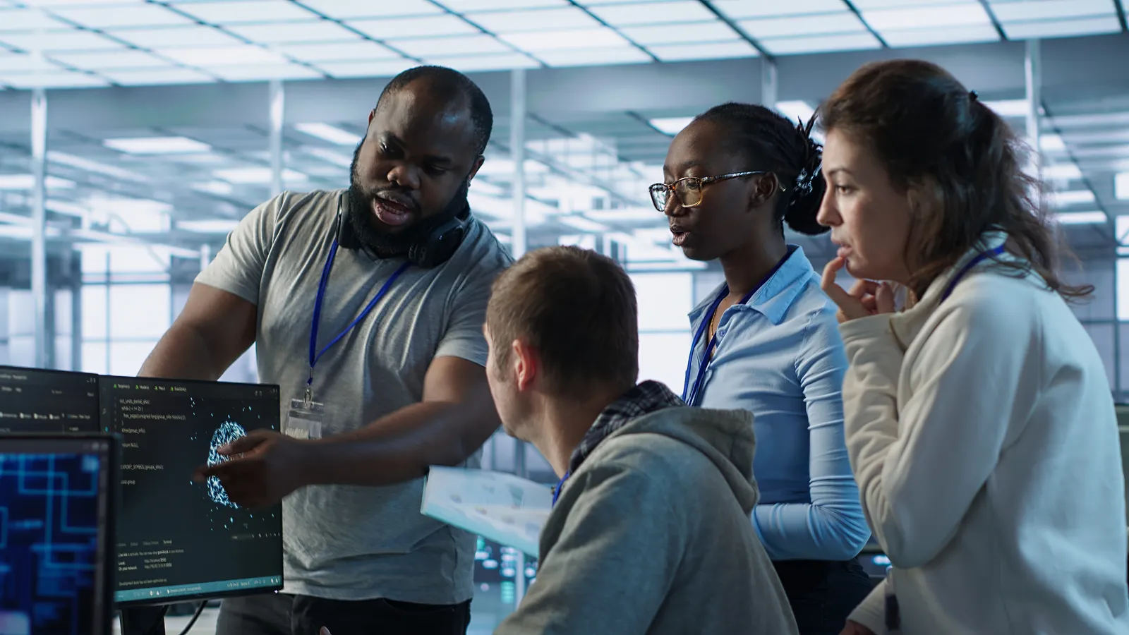 Colleagues in a bright meeting space reviewing a plan on a tablet