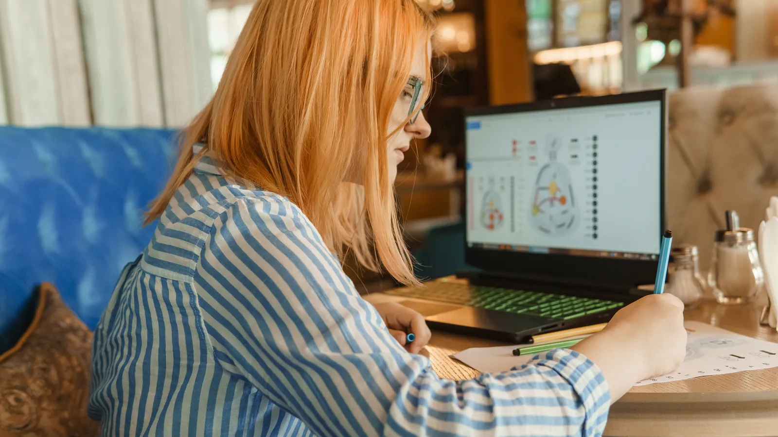 A woman studies a laptop screen in a quiet office